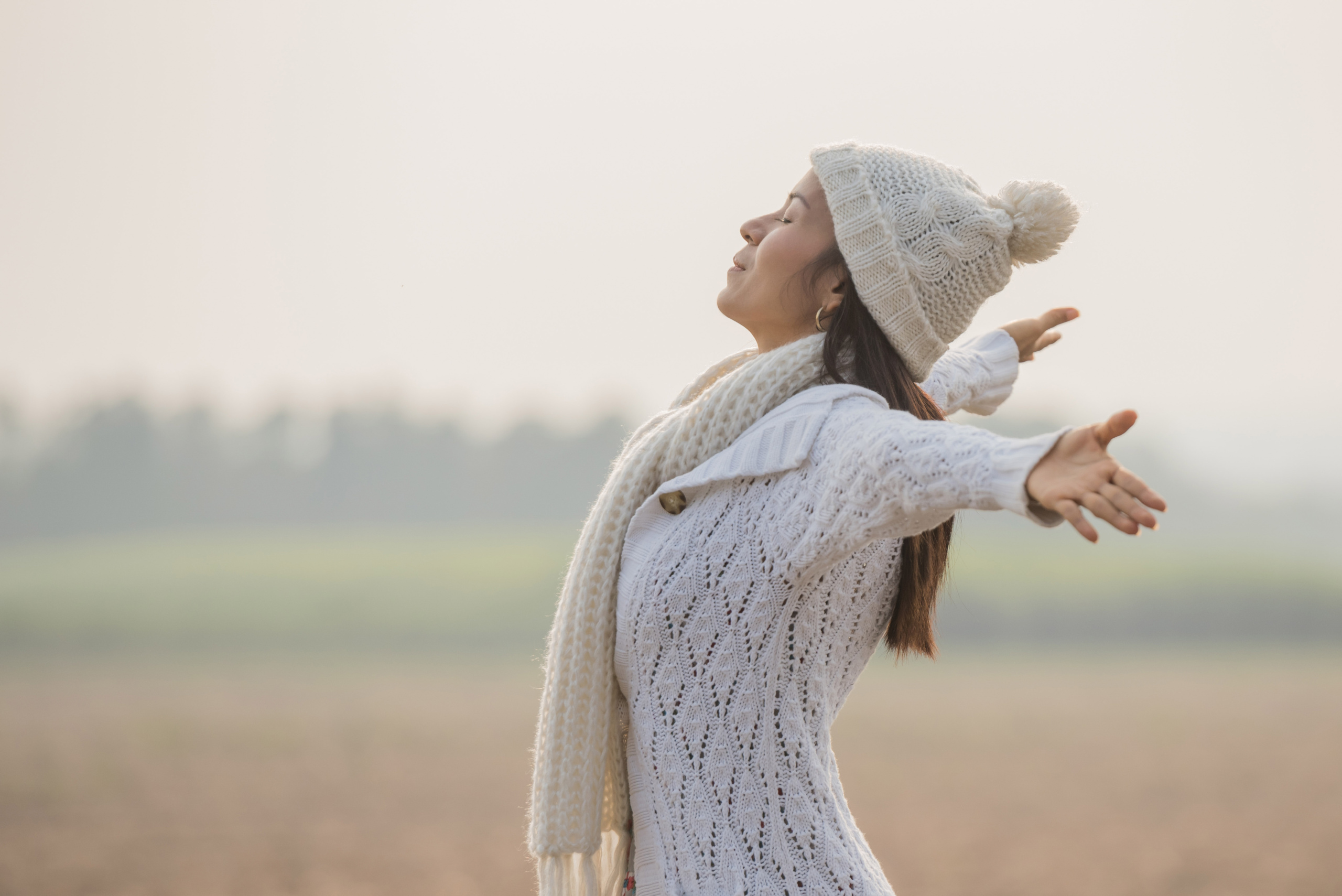 Happy woman enjoying in idyllic nature, celebrating freedom and