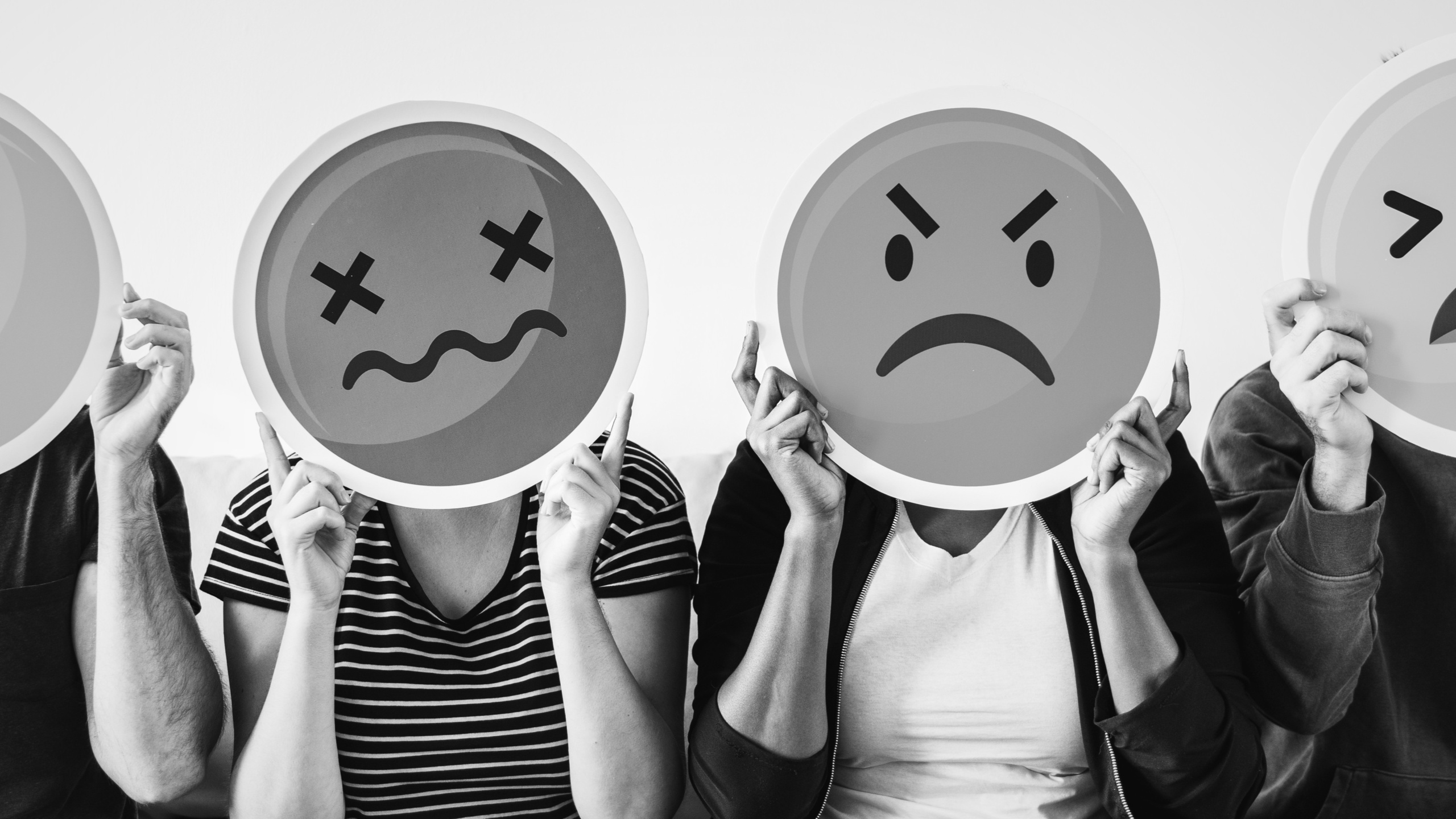 Diverse people holding emoticon