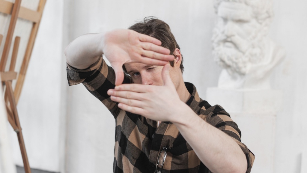 man-artist-making-frame-with-his-fingers-freepik-